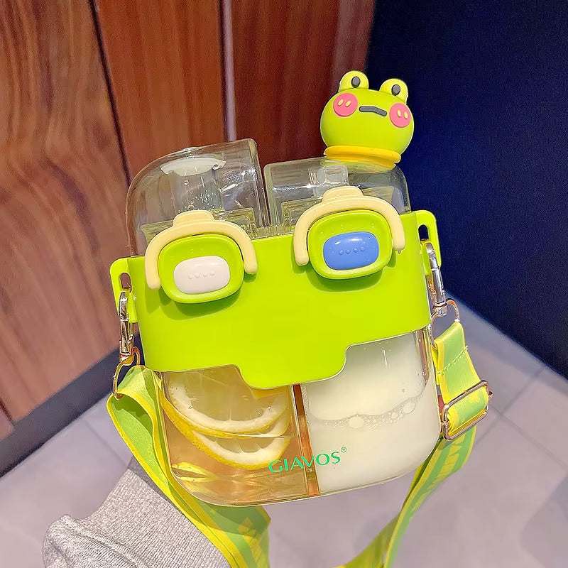 Transparent kawaii water bottle with green frog design on a wooden surface