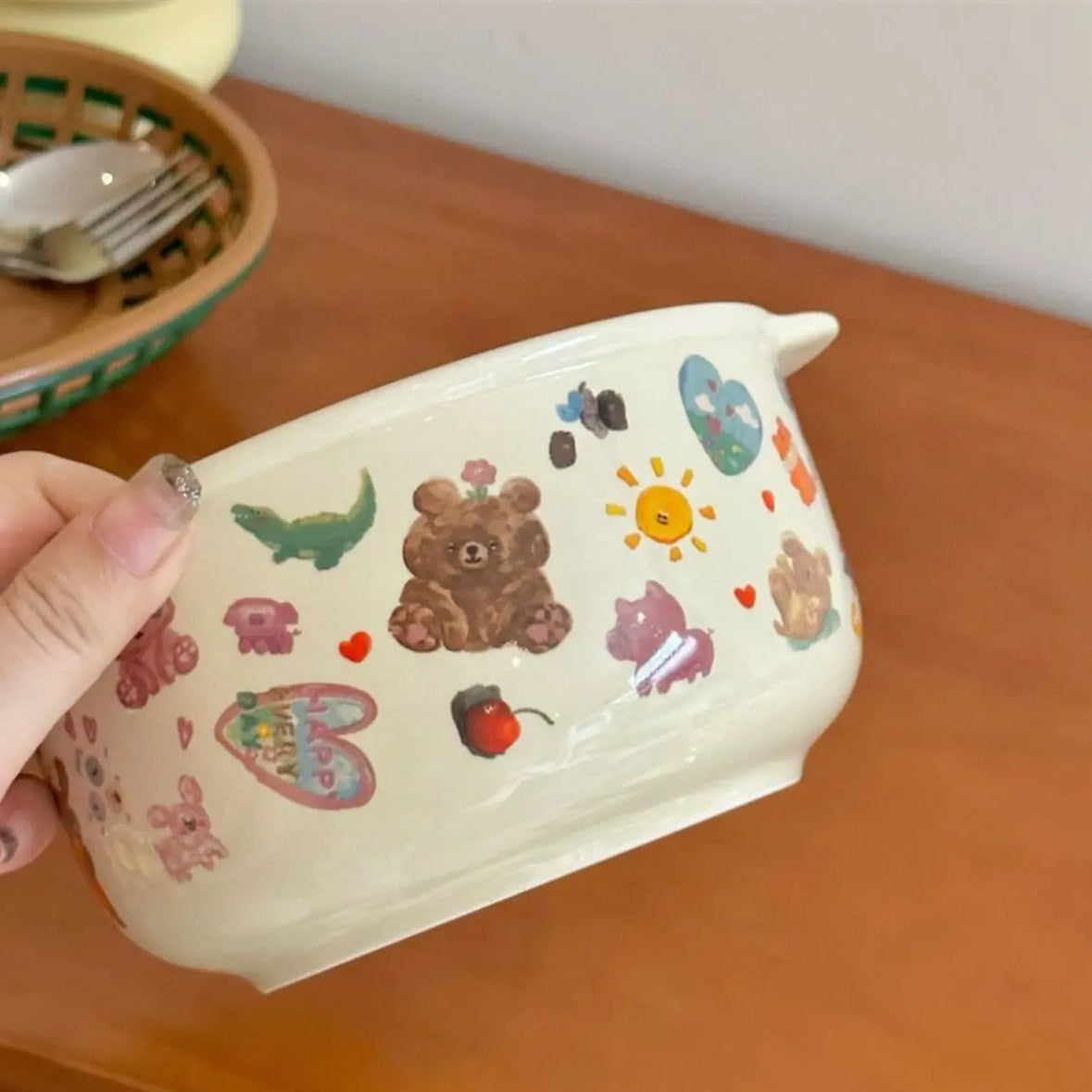 Someone holding a kawaii bowl with bear designs on it