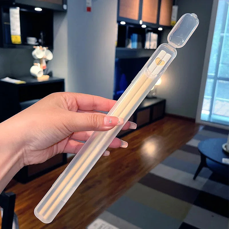 Hand holding a kawaii chopsticks in a living room setting