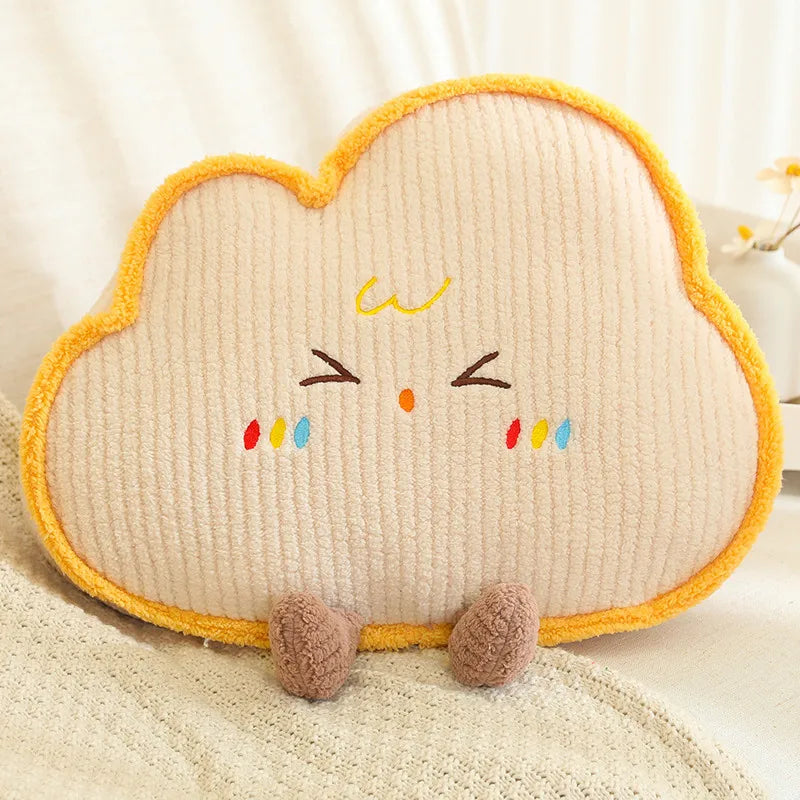 Cloud-shaped kawaii plush toy with a face on a soft surface