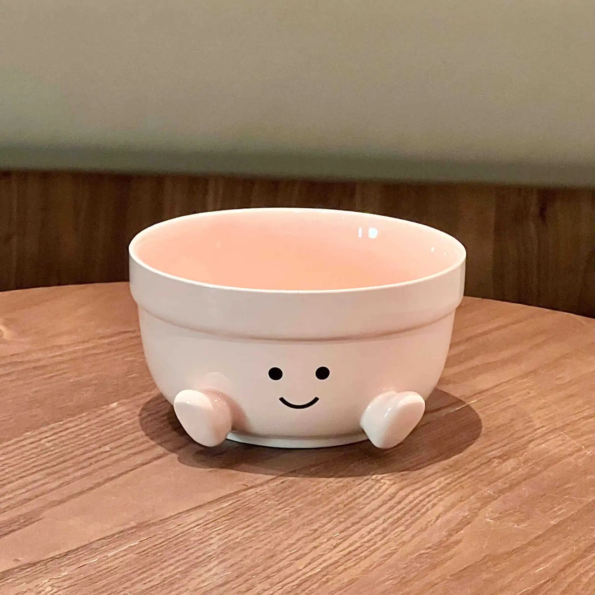 A pink kawaii bowl sitting on a table
