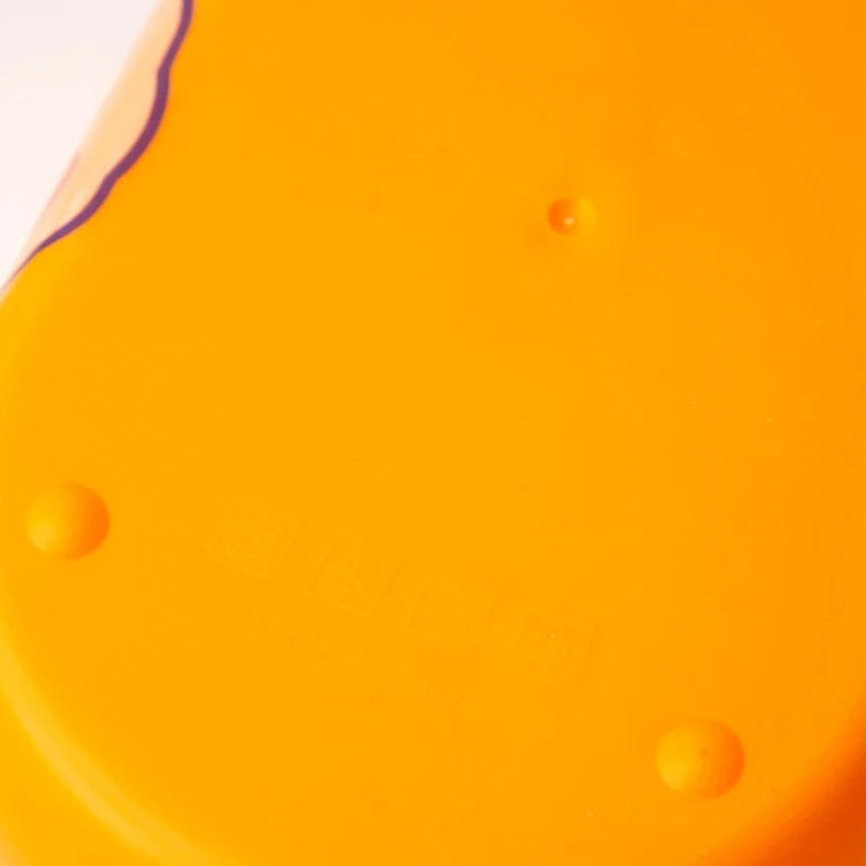 Close-up of a bright orange kawaii food container with a purple border