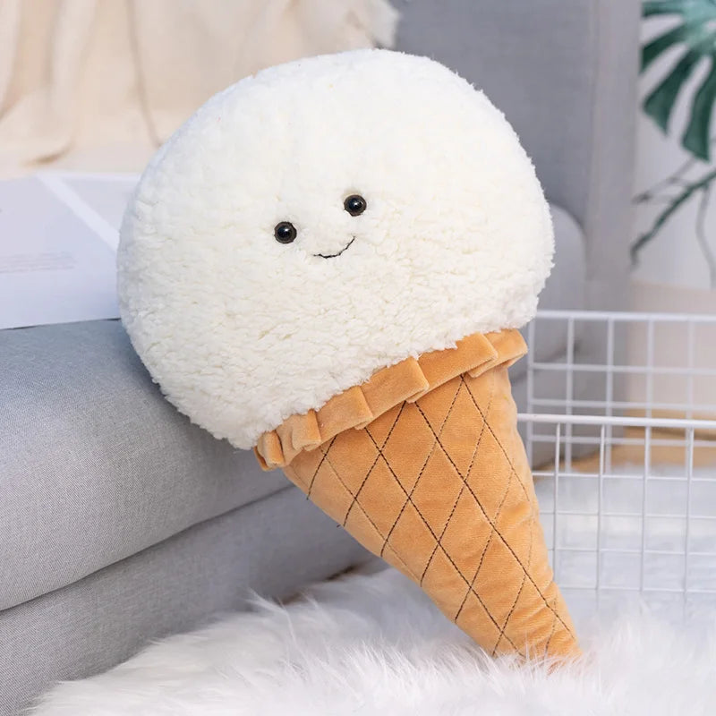 Kawaii plush toy shaped like a white cloud in an orange ice cream cone on a couch.