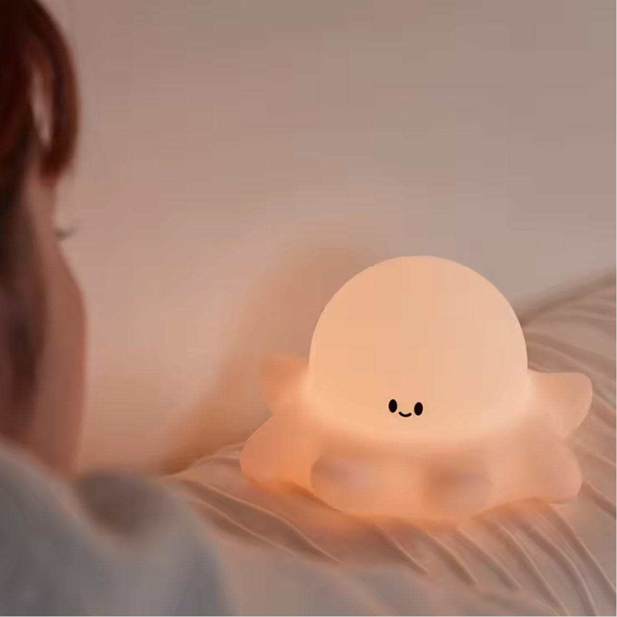 Woman looking at a kawaii octopus night light
