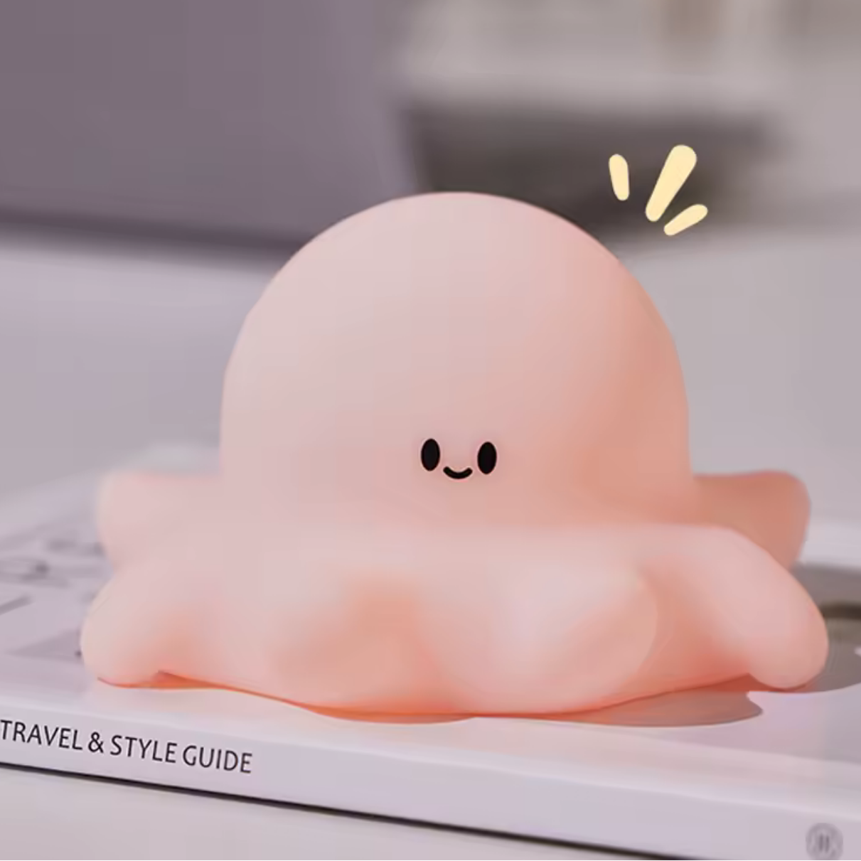 A happy kawaii octopus night light on top of a book
