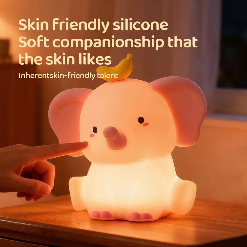Cute animal-shaped kawaii night light on a wooden surface with text about its skin-friendly silicone material.