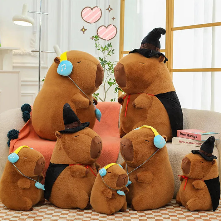 Set of capybara plush toys with various accessories on a checkered floor.