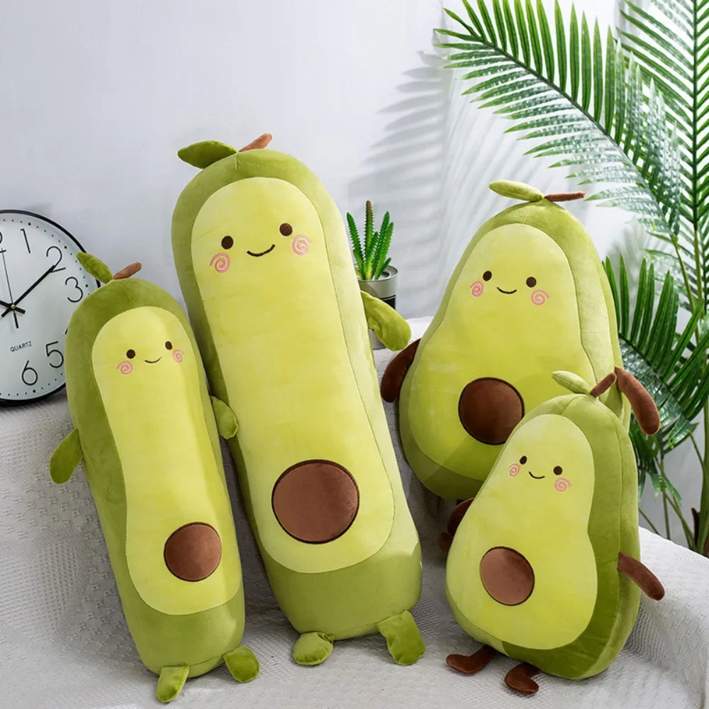 Set of avocado-shaped kawaii plush toys on a white surface with plants and a clock in the background.