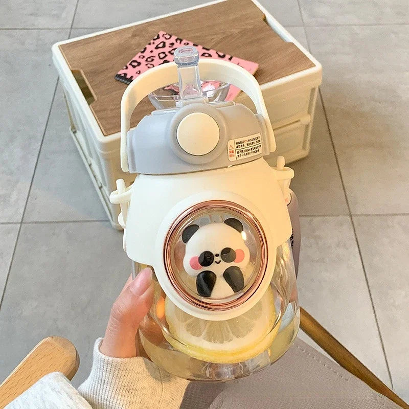 Glass kawaii bottle with panda design held by a hand on a light-colored floor.