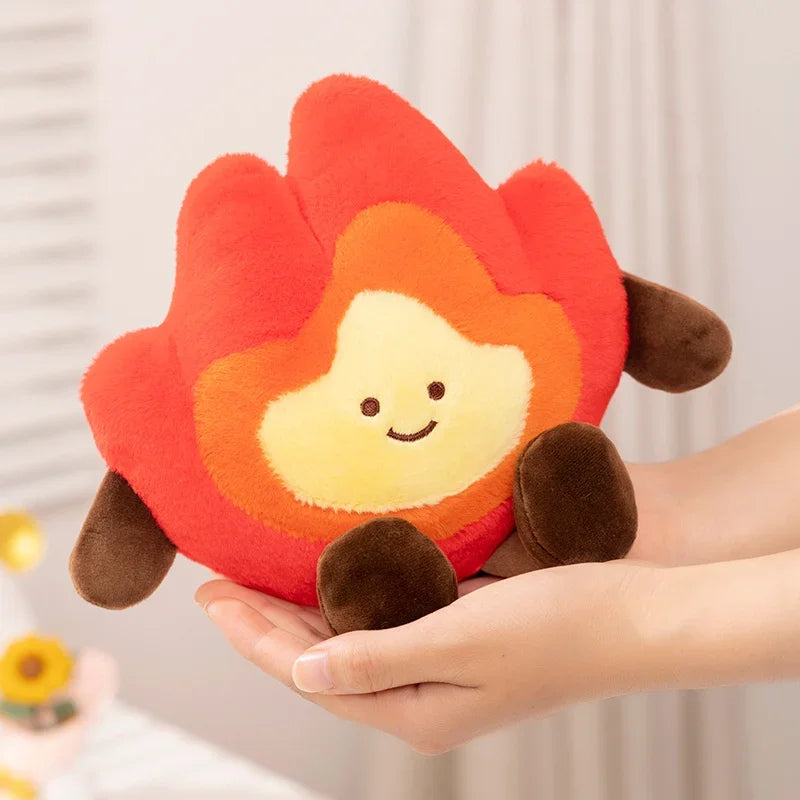 Red and orange kawaii plush toy resembling a flower held in a hand against a neutral background
