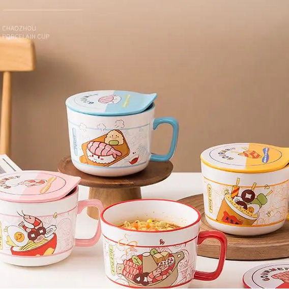 Ceramic kawaii ramen bowls with cartoon designs on a wooden table against a beige wall.