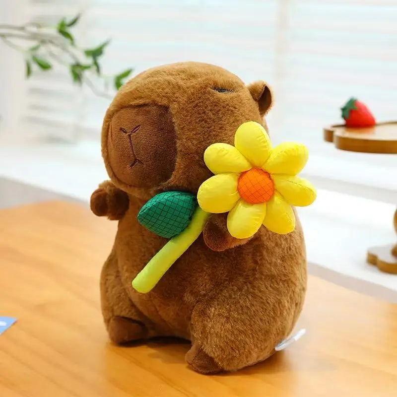 Brown kawaii plush toy holding a yellow flower on a wooden surface