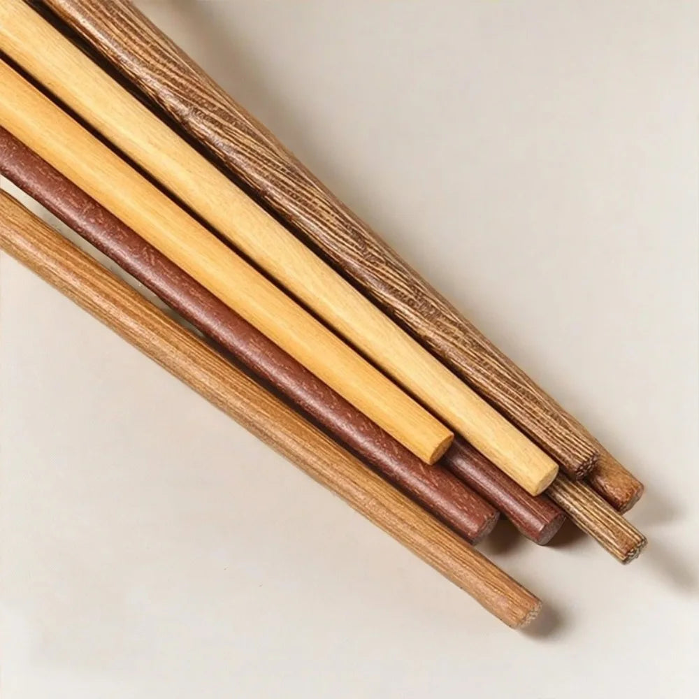 Set of wooden kawaii chopsticks in various colors on a light background