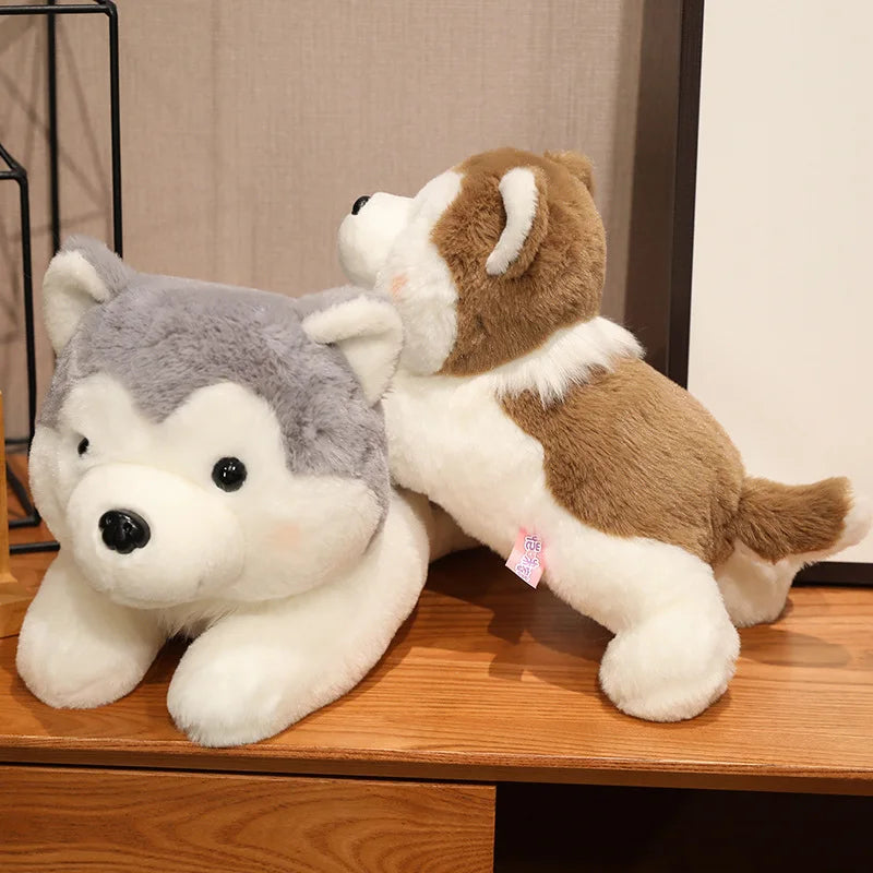 Two kawaii plush dogs, one gray and white, one brown and white, on a wooden surface.