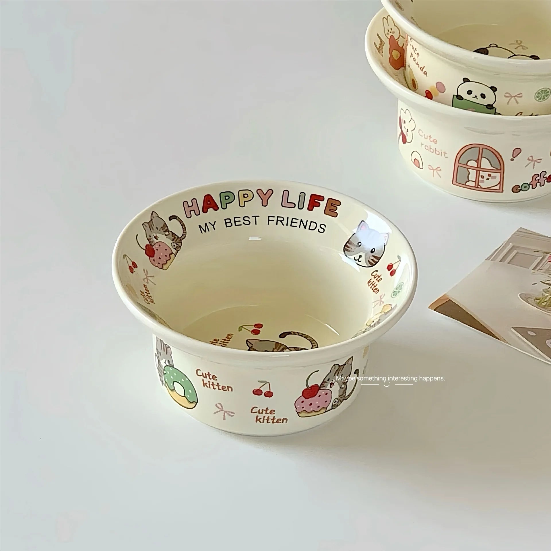 Ceramic kawaii ramen bowl with cat illustrations and text on a white background