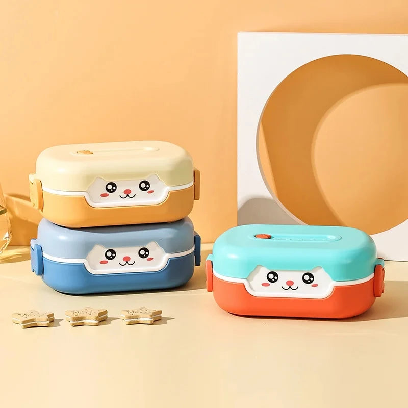 Three colorful kawaii lunch boxes with cartoon faces on a beige background