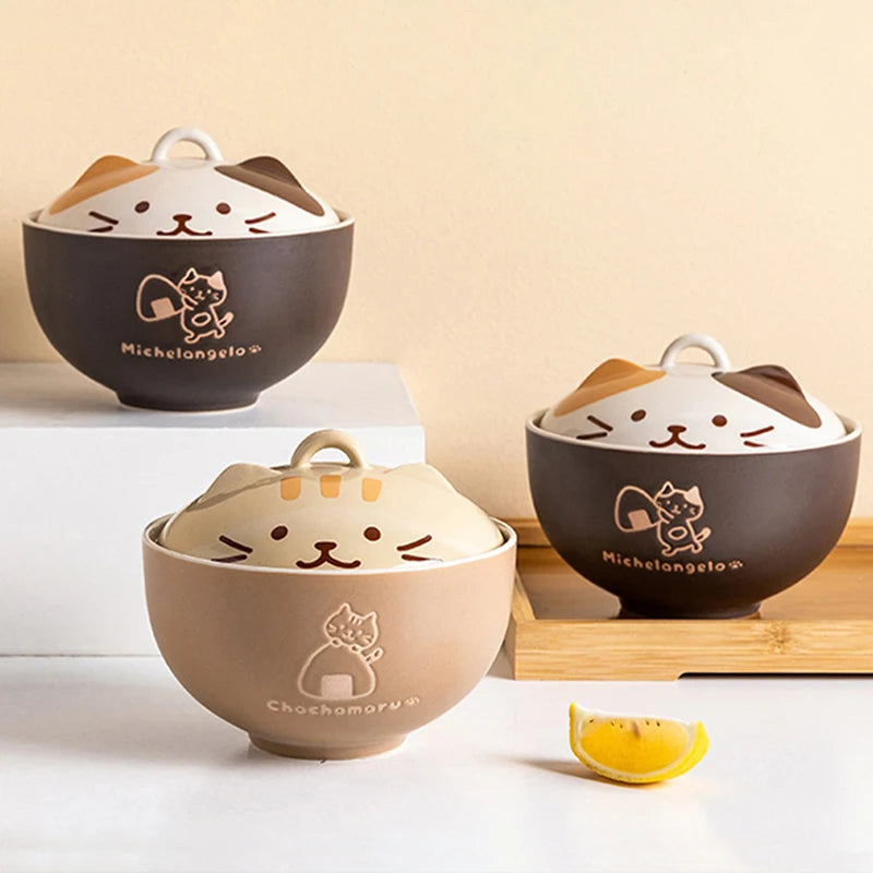 Three cartoon-style ceramic kawaii ramen bowls with cat faces on a light beige background