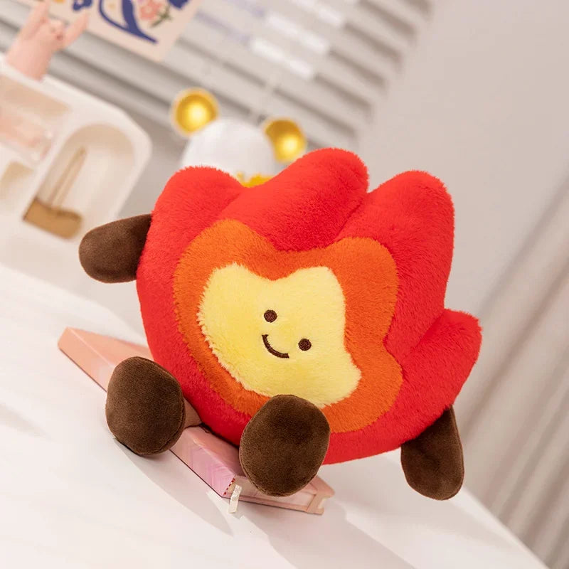 Kawaii plush toy shaped like a red flower with a smiling face on a white surface.