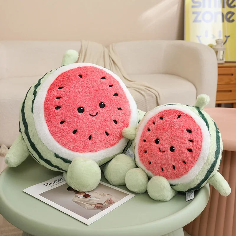Two kawaii plush watermelon toys on a small round table with a magazine underneath.