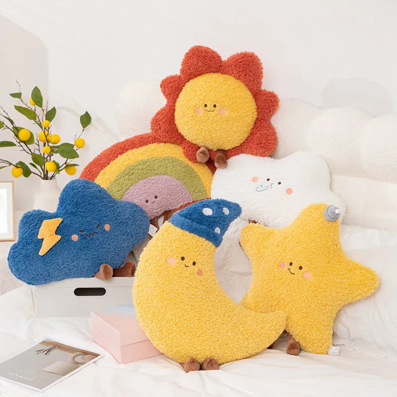 Set of colorful kawaii plush toys shaped like a rainbow, cloud, moon, and star on a white surface.