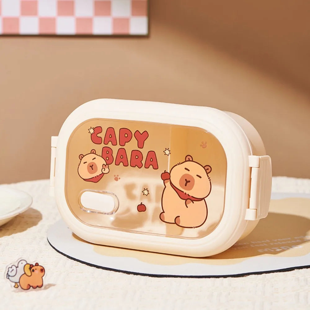 Kawaii capybara-themed lunch box on a checkered tablecloth