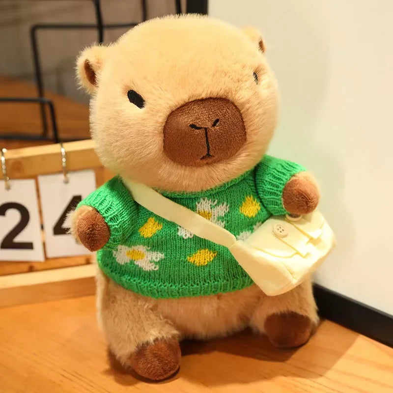 Kawaii plush bear toy wearing a green sweater with flowers and holding a white bag on a wooden floor.