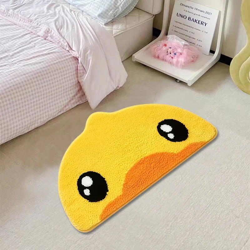 Yellow duck-shaped kawaii rug on a light-colored floor next to a bed.