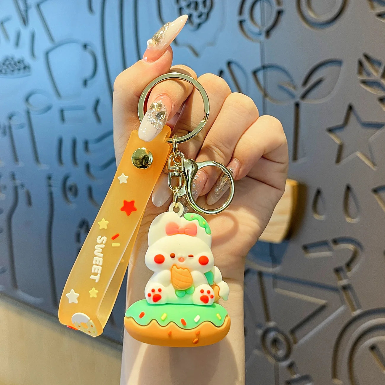 Hand holding a kawaii cute keychain with a decorative background