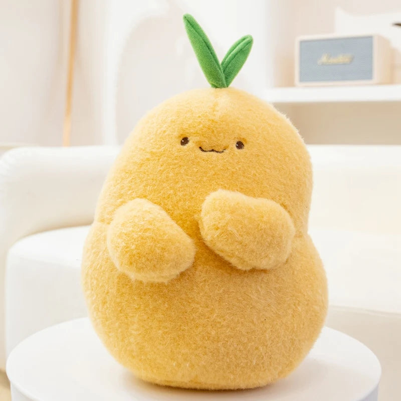 Yellow kawaii plush toy shaped like a pear with a green leaf on a white surface.