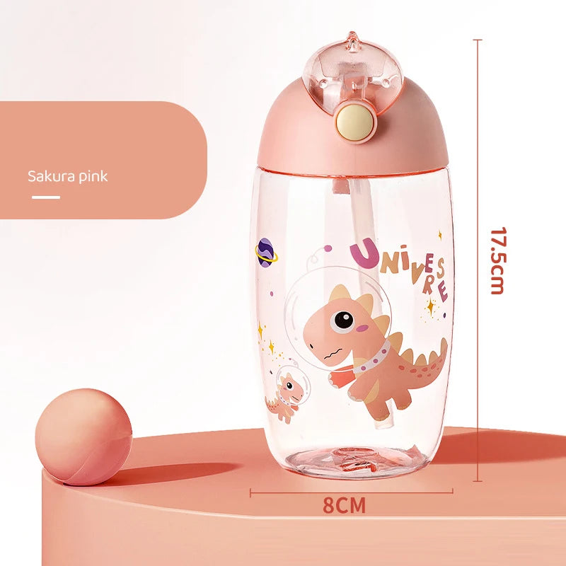 Pink kawaii water bottle with dinosaur design and measurements on a peach-colored background