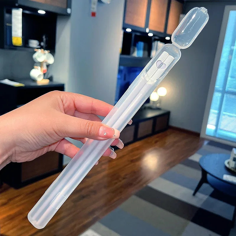 A kawaii chopsticks held by a hand in a room with furniture and decor.