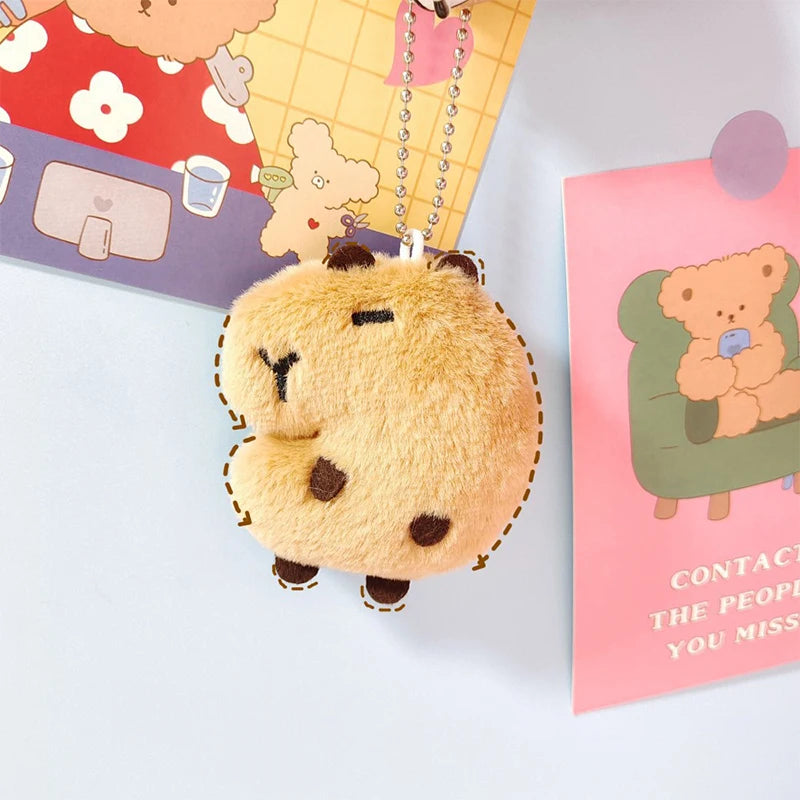 Fluffy bear-shaped kawaii keychain with a card featuring a similar design in the background.
