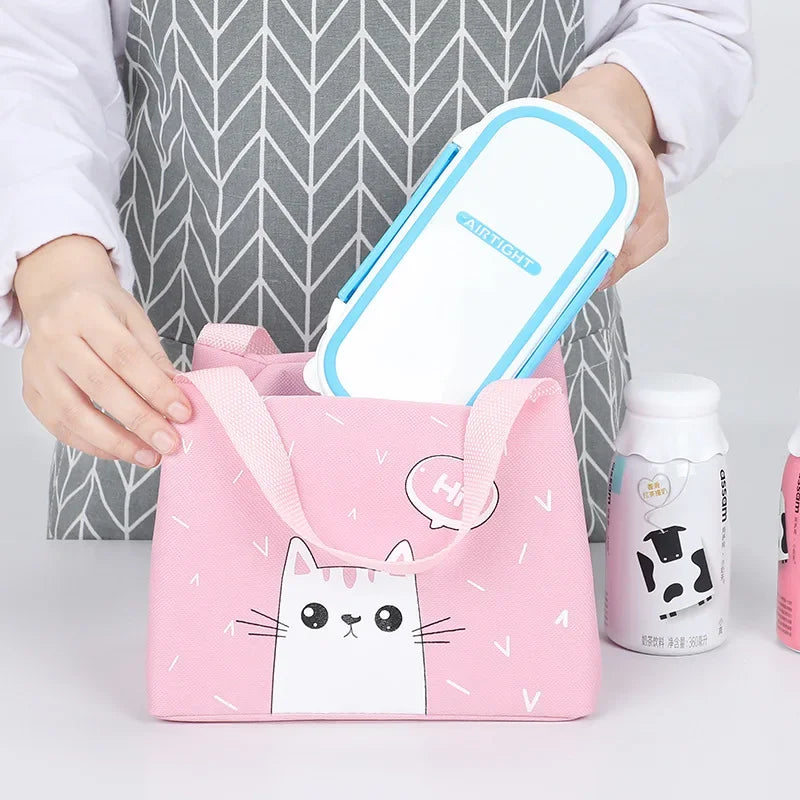Person holding a pink kawaii bag with a cat design, next to a white container and bottles on a light gray background.