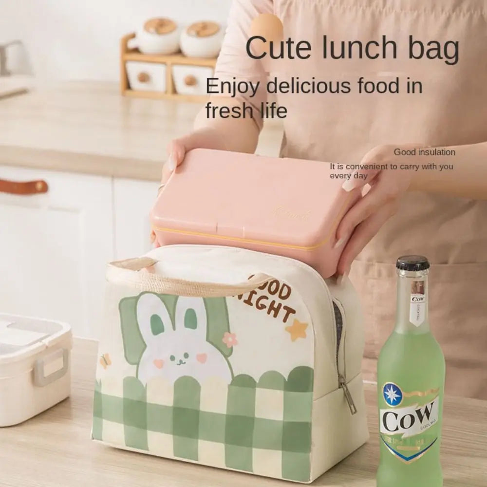 Cute kawaii lunch bag with cartoon design on a wooden surface, next to a bottle of 'Cow' juice.