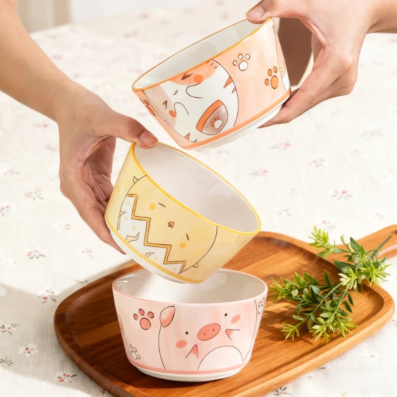 Someone holding three kawaii bowls