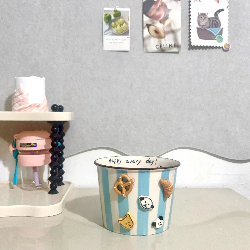 A large striped kawaii ramen bowl with 3D designs on it