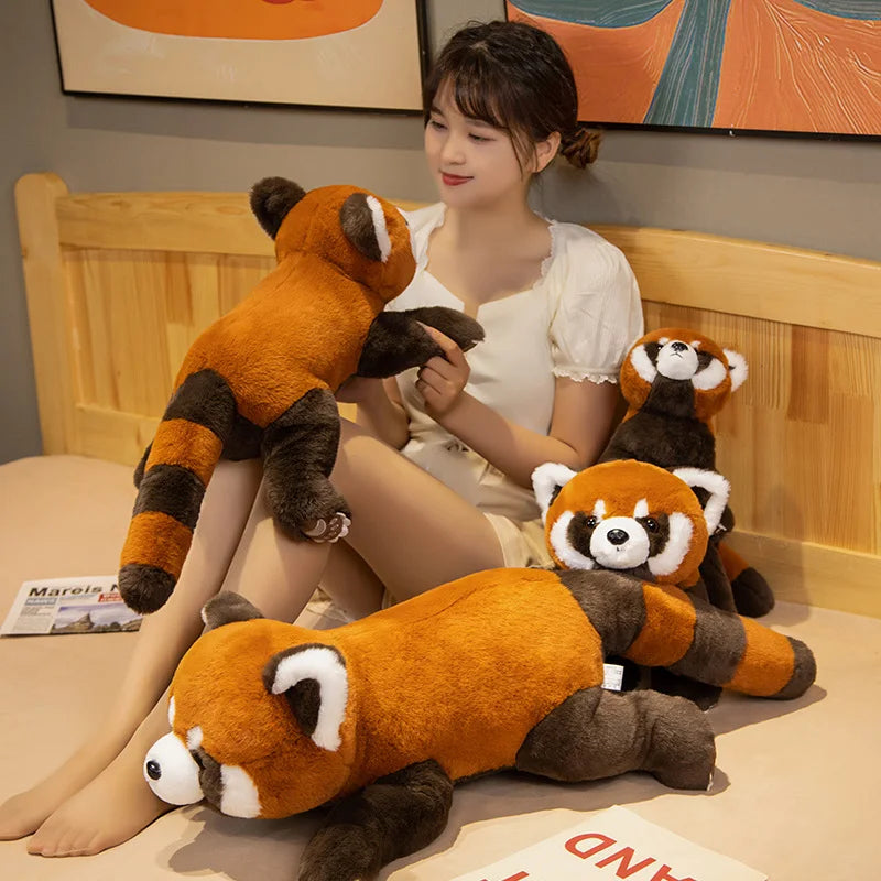 Woman sitting on a bed with three kawaii plush red pandas