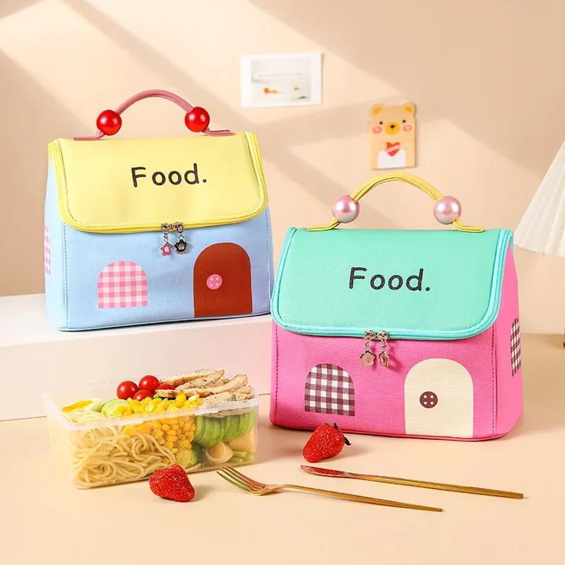 Two colorful kawaii bags with a house design on a beige surface.