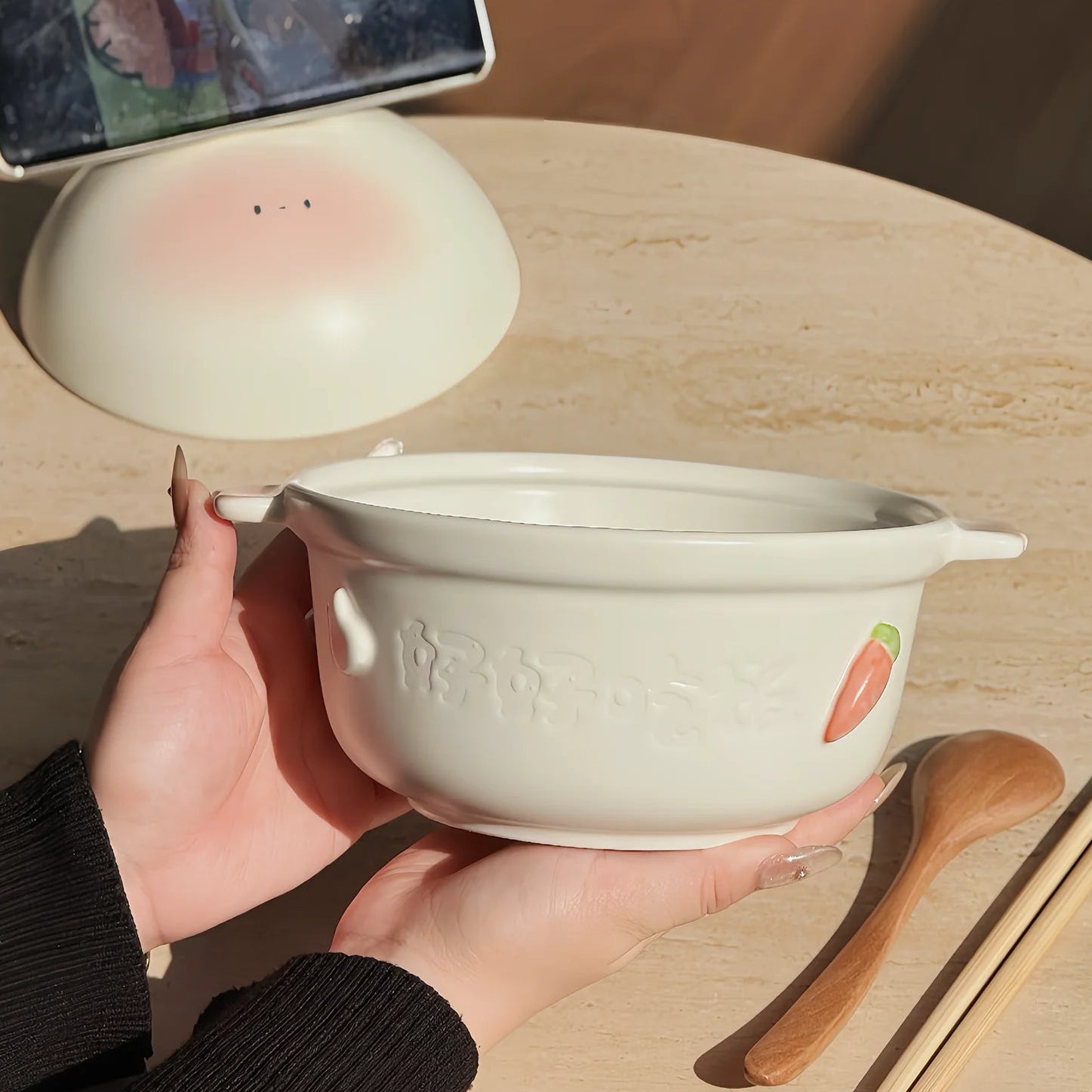 Person holding a white kawaii bowl with handles on a wooden surface, surrounded by 'YUTOPIA' branding.
