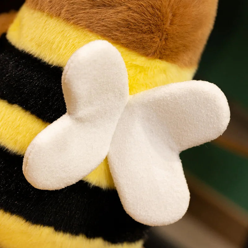 Close-up of a kawaii plush bee toy with yellow body, black stripes, and white wings.