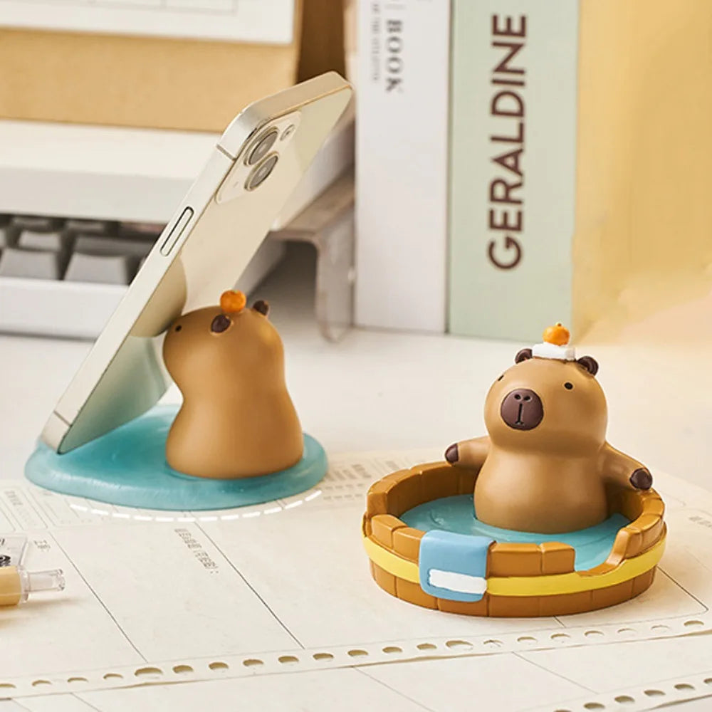 Two cartoon bear kawaii phone holder with a phone stand on a desk.