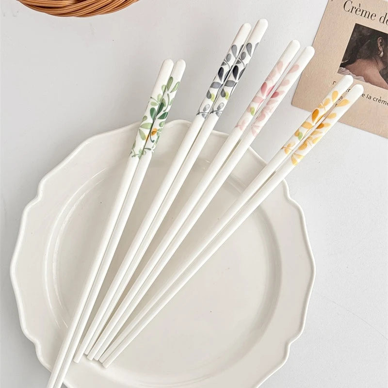 Set of decorative kawaii chopsticks on a white plate with a light background