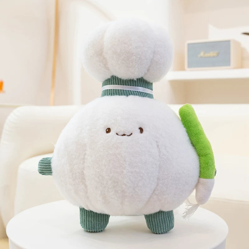 Kawaii plush toy resembling a white creature with green accents on a white surface
