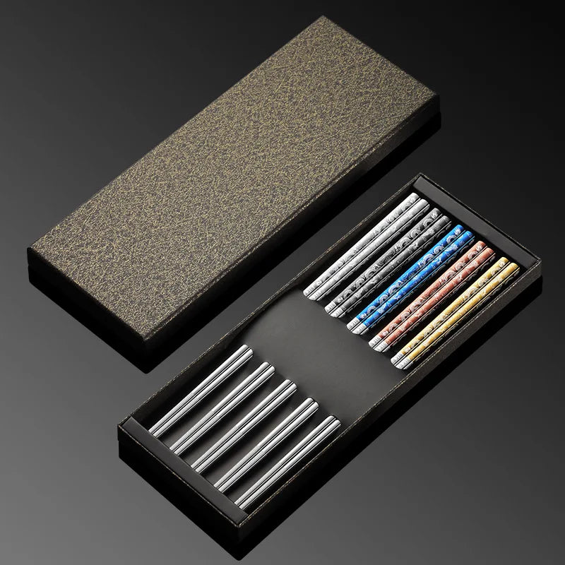Set of colored kawaii chopsticks in a black box on a dark background