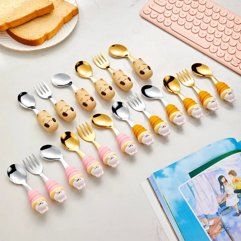 Set of children's kawaii utensils and forks with cartoon character handles on a table.
