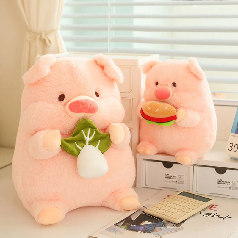 Two pink pig kawaii plush toys holding a leaf and a burger on a surface with a window in the background.