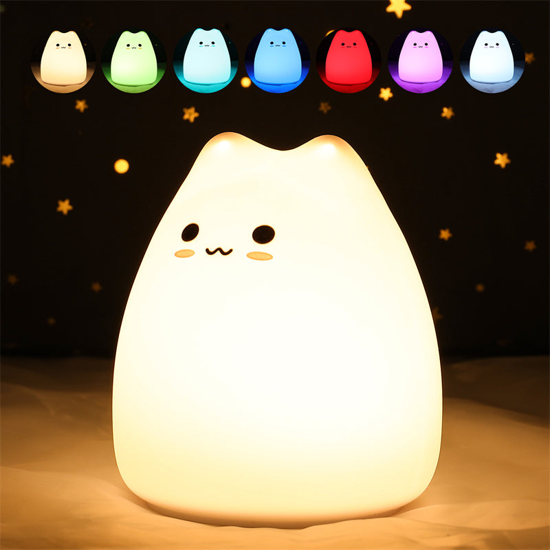 Kawaii cat-shaped night light glowing with a warm yellow hue on a dark background.