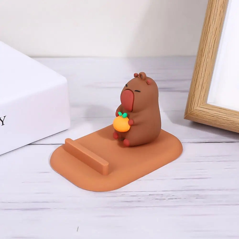 Brown capybara themed kawaii phone holder on a white surface with a light gray background