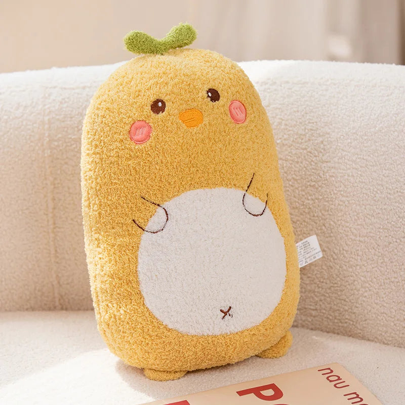 Kawaii plush toy resembling a yellow chick with a green bow on a beige couch.