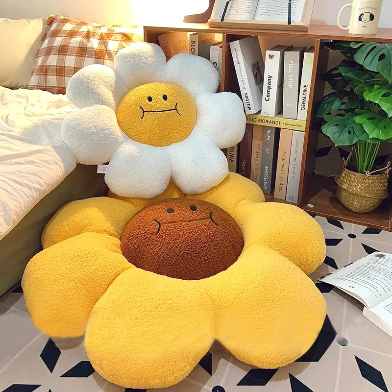 Floral-shaped kawaii cushion with smiling face on a floor next to a bookshelf